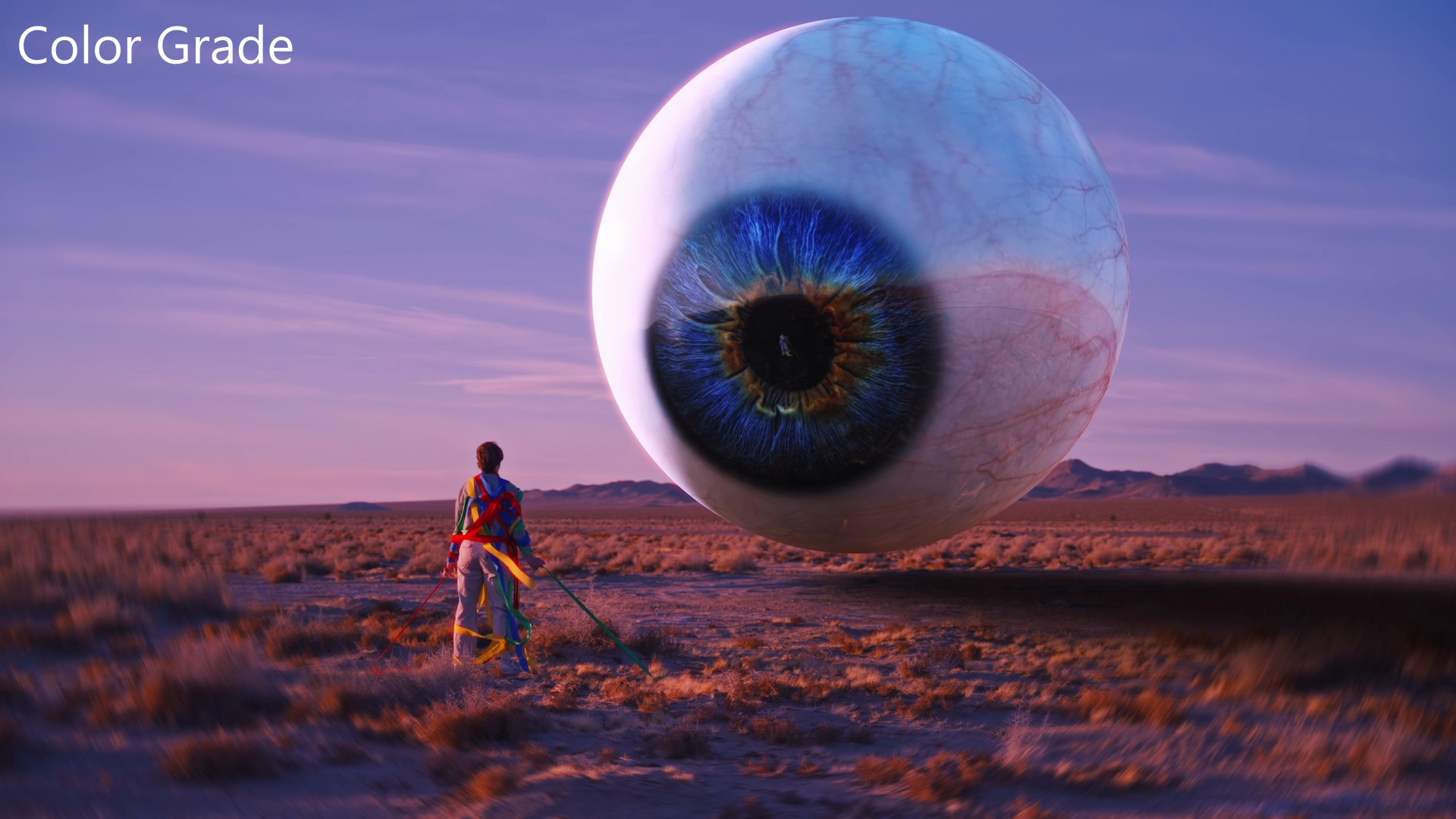 A monumental blue eyeball floating above desert terrain